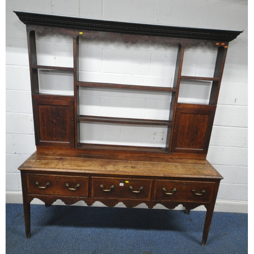163 - A GEORGIAN OAK DRESSER, the plate rack fitted with an arrangement of shelving, and two cupboard door... 