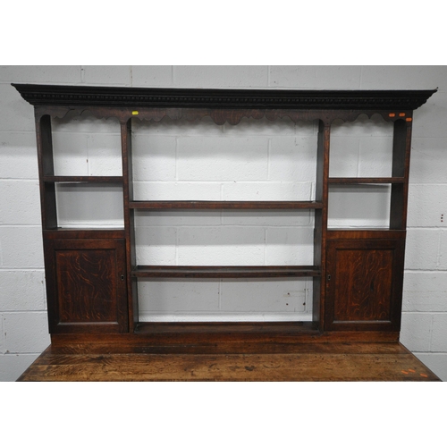 163 - A GEORGIAN OAK DRESSER, the plate rack fitted with an arrangement of shelving, and two cupboard door... 