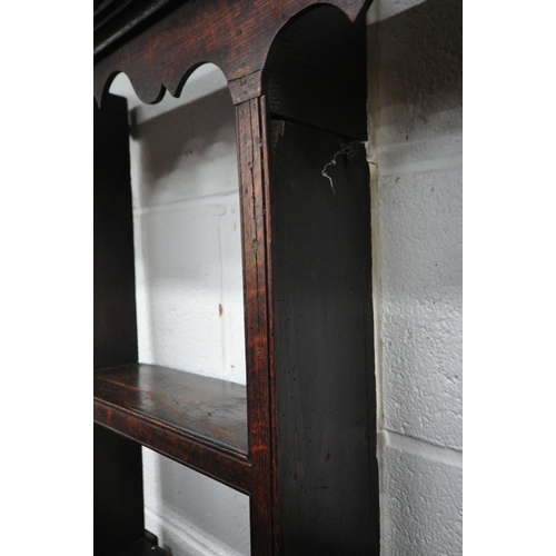163 - A GEORGIAN OAK DRESSER, the plate rack fitted with an arrangement of shelving, and two cupboard door... 