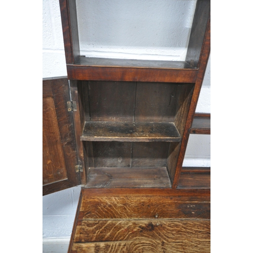 163 - A GEORGIAN OAK DRESSER, the plate rack fitted with an arrangement of shelving, and two cupboard door... 