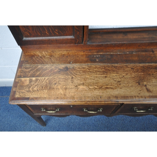 163 - A GEORGIAN OAK DRESSER, the plate rack fitted with an arrangement of shelving, and two cupboard door... 