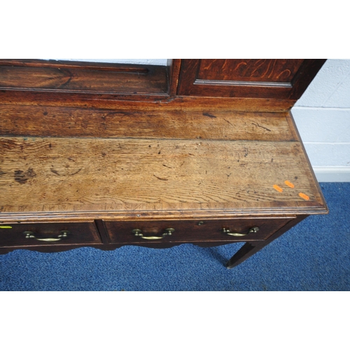 163 - A GEORGIAN OAK DRESSER, the plate rack fitted with an arrangement of shelving, and two cupboard door... 