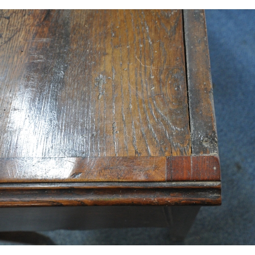 163 - A GEORGIAN OAK DRESSER, the plate rack fitted with an arrangement of shelving, and two cupboard door... 