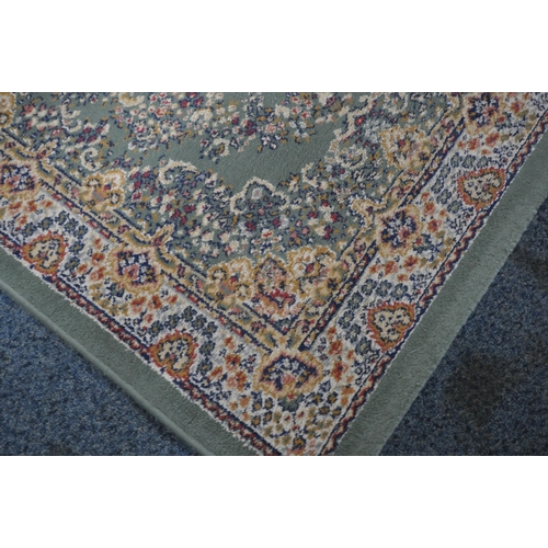 164 - A GREEN GROUND SAMARKAND RECTANGULAR RUG, with repeating foliate patterns, and a multi-strap border,... 