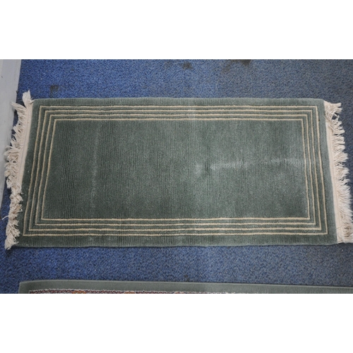 164 - A GREEN GROUND SAMARKAND RECTANGULAR RUG, with repeating foliate patterns, and a multi-strap border,... 