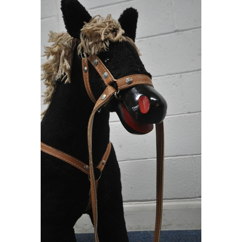 165 - A BLACK UPHOLSTERED ROCKING HORSE, height 81cm, condition report: overall good condition