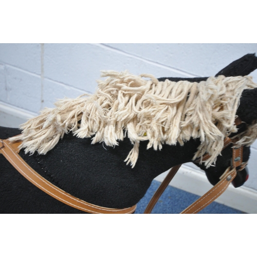 165 - A BLACK UPHOLSTERED ROCKING HORSE, height 81cm, condition report: overall good condition