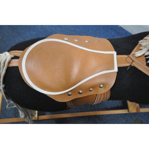 165 - A BLACK UPHOLSTERED ROCKING HORSE, height 81cm, condition report: overall good condition