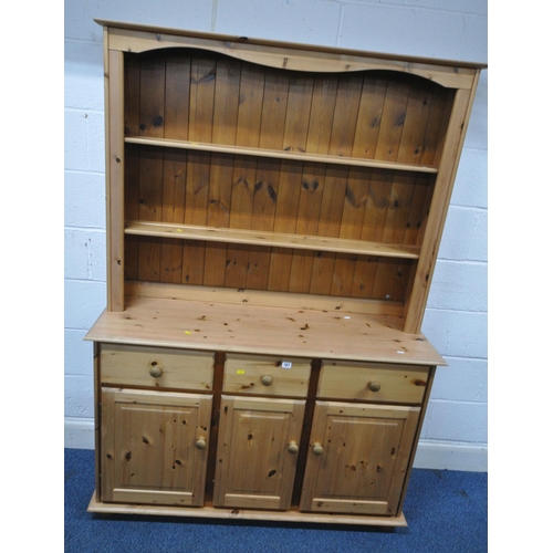 167 - A MODERN PINE DRESSER, the two tier plate rack atop a base with three drawers, over three cupboard d... 