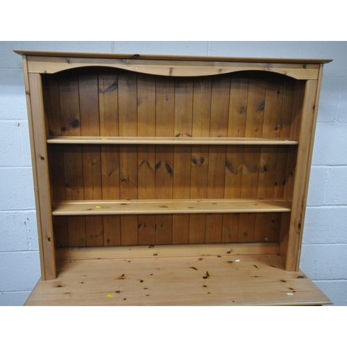 167 - A MODERN PINE DRESSER, the two tier plate rack atop a base with three drawers, over three cupboard d... 