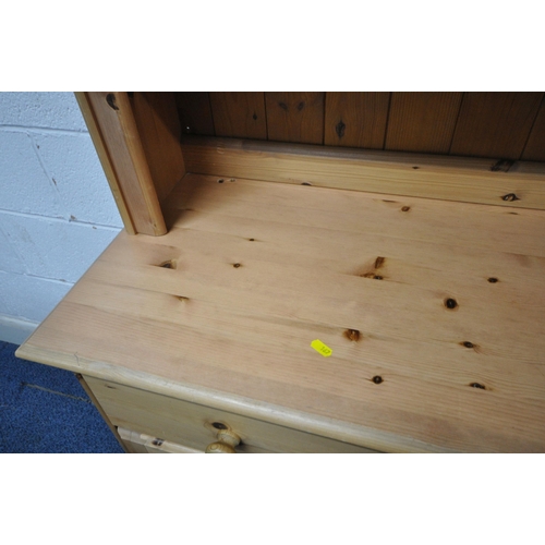 167 - A MODERN PINE DRESSER, the two tier plate rack atop a base with three drawers, over three cupboard d... 