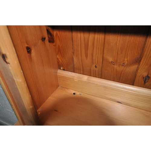 167 - A MODERN PINE DRESSER, the two tier plate rack atop a base with three drawers, over three cupboard d... 