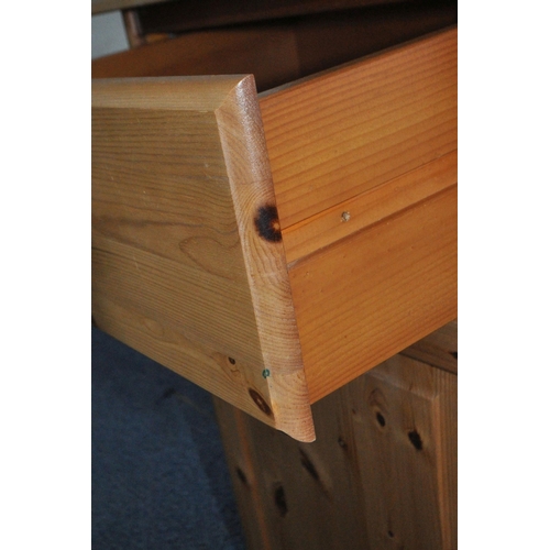 167 - A MODERN PINE DRESSER, the two tier plate rack atop a base with three drawers, over three cupboard d... 
