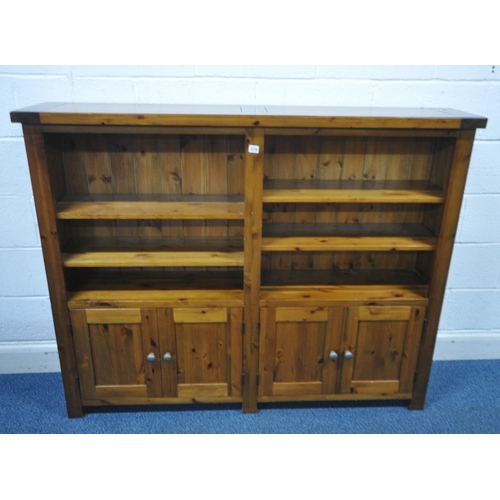 174 - A MODERN PINE BOOKCASE, fitted with four cupboard doors, width 150cm x depth 30cm x height 120cm, co... 