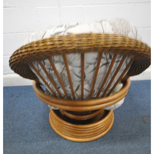 176 - A RATTAN SWIVEL ROCKING CHAIR, with foliate upholstery, width 77cm x depth 97cm x height 96cm, condi... 