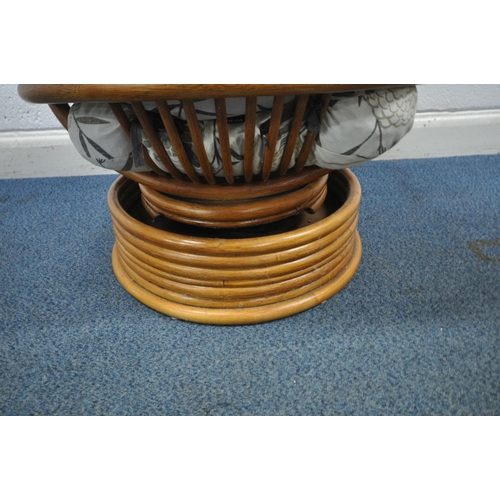 176 - A RATTAN SWIVEL ROCKING CHAIR, with foliate upholstery, width 77cm x depth 97cm x height 96cm, condi... 
