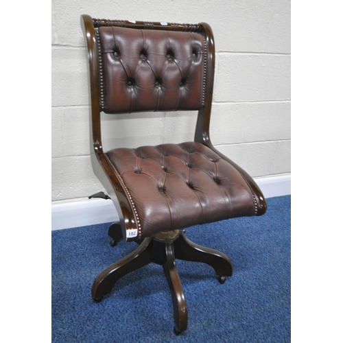 182 - A BURGUNDY LEATHER SWIVEL OFFICE CHAIR, raised on five legs with castors, width 50cm x depth 64cm x ... 