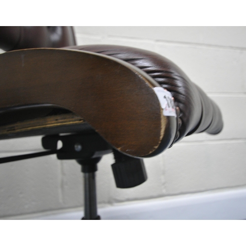 182 - A BURGUNDY LEATHER SWIVEL OFFICE CHAIR, raised on five legs with castors, width 50cm x depth 64cm x ... 