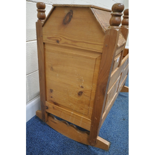 191 - A LATE 20TH CENTURY PINE ROCKING CRIB, with a raised back and hood, length 95cm x depth 54cm x heigh... 