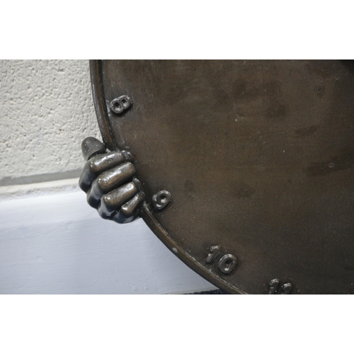194 - ANDRE WALLACE, A BRONZE EFFECT 'CLOWN' WALL HANGING SUN DIAL, disk diameter 49cm x width 54cm x dept... 
