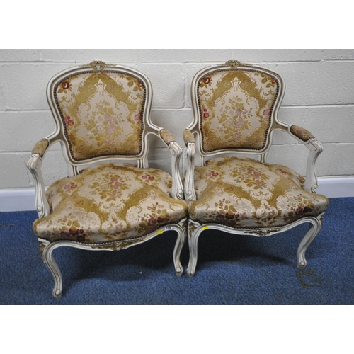 198 - A PAIR OF PAINTED FRENCH ARMCHAIRS, with gold foliate details, floral upholstery, raised on front ca... 