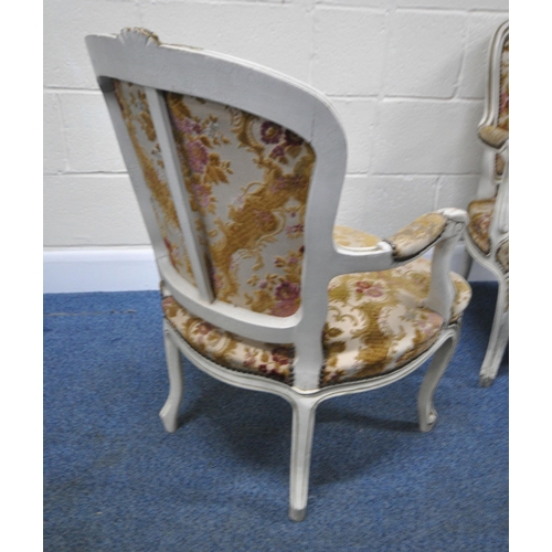 198 - A PAIR OF PAINTED FRENCH ARMCHAIRS, with gold foliate details, floral upholstery, raised on front ca... 