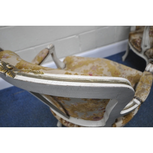 198 - A PAIR OF PAINTED FRENCH ARMCHAIRS, with gold foliate details, floral upholstery, raised on front ca... 