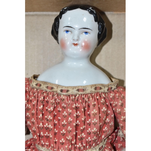 1020 - A NINETEENTH CENTURY PORCELAIN HEAD DOLL, with hand stitched cloth body and legs, kid leather arms a...