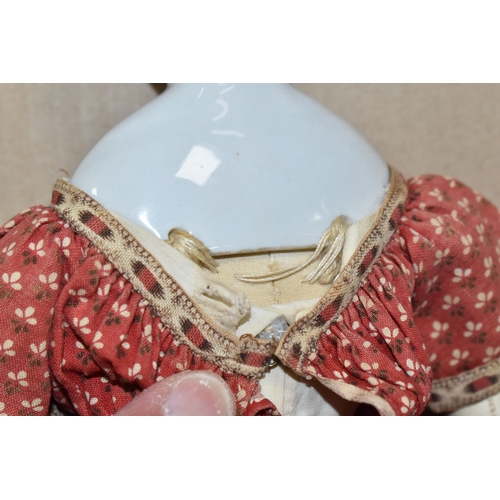 1020 - A NINETEENTH CENTURY PORCELAIN HEAD DOLL, with hand stitched cloth body and legs, kid leather arms a...