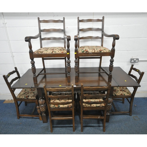 141 - STANLEY WOOD OF OLNEY, BUCKINGHAMSHIRE, A 20TH CENTURY OAK DRAW LEAF DINING TABLE, raised on bulbous...