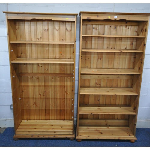 145 - TWO MODERN PINE SHALLOW BOOKCASES, with a large quantity of shelves, largest width 91cm x depth 27cm... 