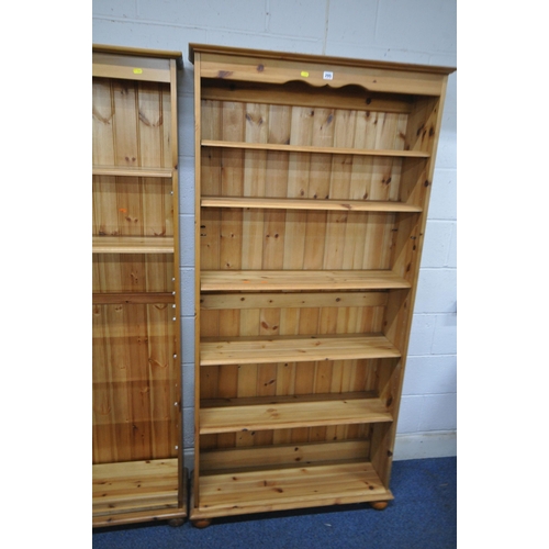 145 - TWO MODERN PINE SHALLOW BOOKCASES, with a large quantity of shelves, largest width 91cm x depth 27cm... 