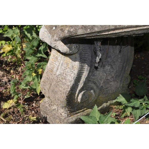 9 - A CONCRETE GARDEN BENCH, with a curved seat and scrolled bases, length 128cm, Condition Report: aggr... 