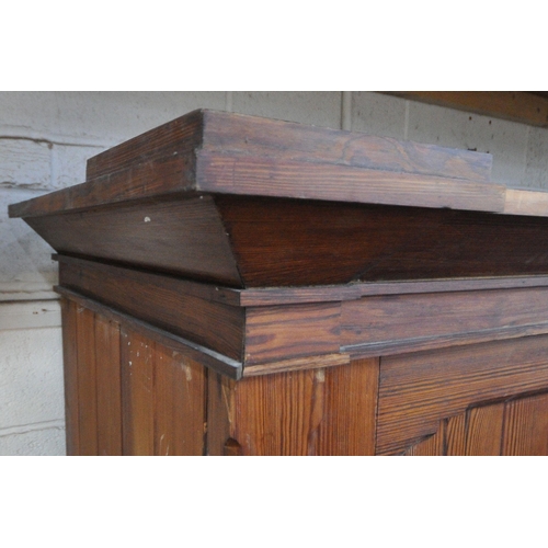 151 - A 19TH CENTURY PITCH PINE WARDROBE, fitted with two large doors, flanking smaller double doors over ... 
