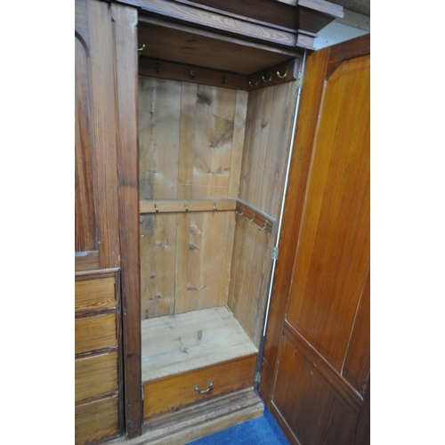 151 - A 19TH CENTURY PITCH PINE WARDROBE, fitted with two large doors, flanking smaller double doors over ... 