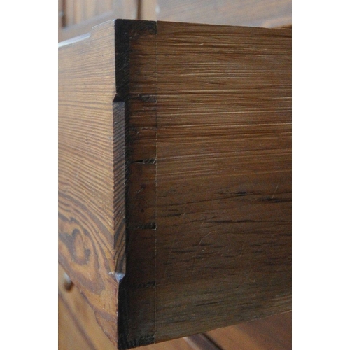 151 - A 19TH CENTURY PITCH PINE WARDROBE, fitted with two large doors, flanking smaller double doors over ... 