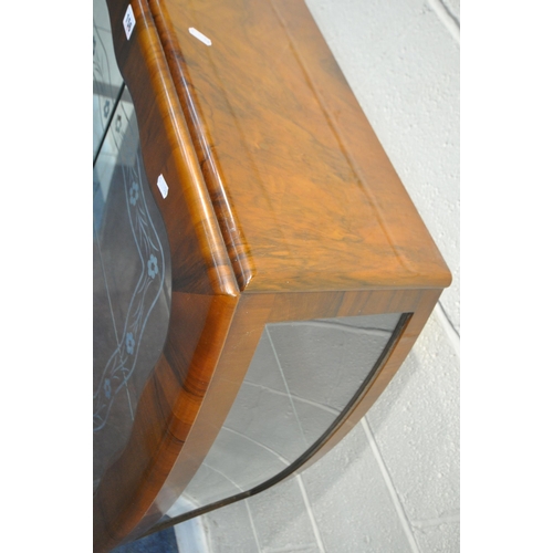 156 - AN ART DECO WALNUT CHINA CABINET, the double glass sliding doors with foliate patterns, that are enc... 