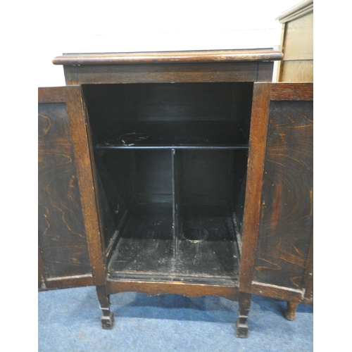 170 - AN EARLY 20TH CENTURY OAK MEDIA CABINET, with a hinged lid, a distressed fretwork front, and a singl... 