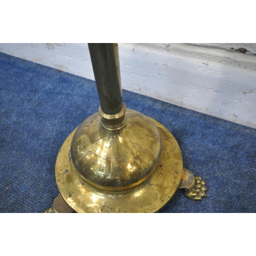 172 - A BRASS TELESCOPIC STANDARD LAMP, on a circular stepped base, with three paw feet, maximum height 16... 
