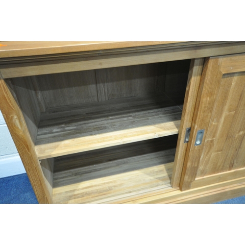 185 - A LARGE MODERN OAK HOUSEKEEPERS CUPBOARD, fitted with triple glass sliding doors, six drawers, atop ... 