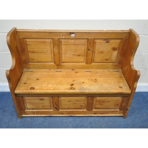 182 - A MODERN PINE SETTLE, with shaped armrests, flanking a hinged seat, width 128cm x depth 46cm x heigh... 