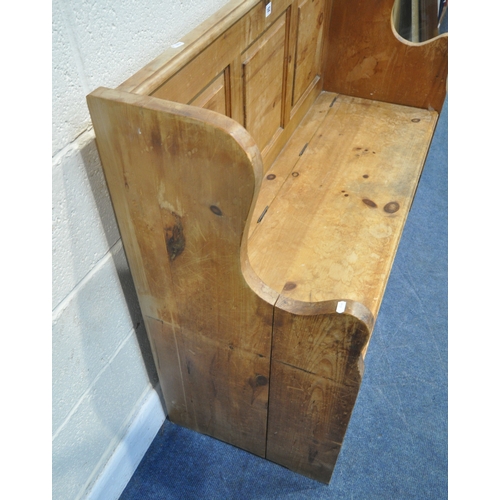182 - A MODERN PINE SETTLE, with shaped armrests, flanking a hinged seat, width 128cm x depth 46cm x heigh... 