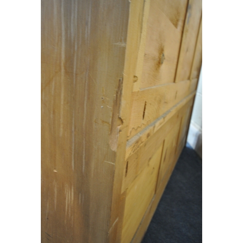 182 - A MODERN PINE SETTLE, with shaped armrests, flanking a hinged seat, width 128cm x depth 46cm x heigh... 