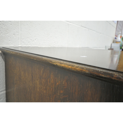 185 - A 20TH CENTURY OAK CHEST OF FOUR DRAWERS, raised on castors, width 87cm x depth 42cm x height 108cm,... 