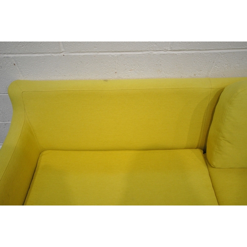 201 - A MODERN LIME GREEN UPHOLSTERED SOFA, raised on cylindrical tapered legs, length 202cm x depth 90cm ... 