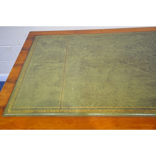 211 - A REPRODUCTION YEW WOOD TWIN PEDESTAL DESK, with a green leather writing surface, fitted with an arr... 