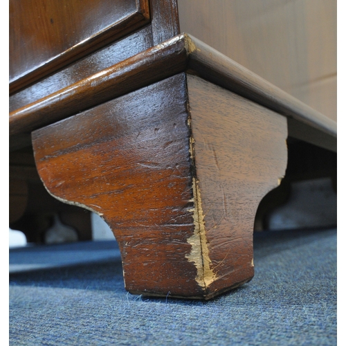 211 - A REPRODUCTION YEW WOOD TWIN PEDESTAL DESK, with a green leather writing surface, fitted with an arr... 