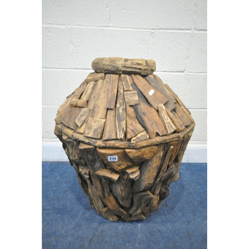 239 - A LARGE DECORATIVE RUSTIC FLOOR VASE, thats crated from teak root wood, of a tapered form, with a c... 