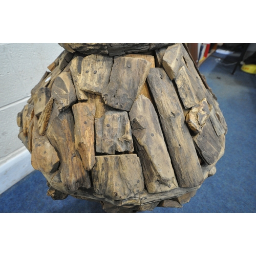239 - A LARGE DECORATIVE RUSTIC FLOOR VASE, thats crated from teak root wood, of a tapered form, with a c... 