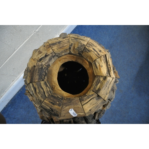 239 - A LARGE DECORATIVE RUSTIC FLOOR VASE, thats crated from teak root wood, of a tapered form, with a c... 